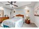A carpeted bedroom with a fan, side tables, and a large window for natural light at 5519 Genoa St, Denver, CO 80249