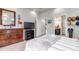 Bedroom features a large dresser, TV, walk-in closet, and ensuite bathroom, providing ample storage and convenience at 5519 Genoa St, Denver, CO 80249