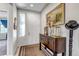 Bright foyer featuring a stylish console table, decorative artwork, and ample natural light at 5519 Genoa St, Denver, CO 80249