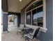 Inviting covered front porch offering a seating area with neighborhood views and natural light at 5519 Genoa St, Denver, CO 80249