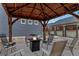 A cozy outdoor gazebo with seating and a fire pit, ideal for relaxing evenings at 5519 Genoa St, Denver, CO 80249