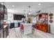 Well-equipped kitchen with stainless steel appliances and bar seating, seamlessly connected to living space at 5519 Genoa St, Denver, CO 80249