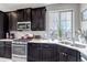 The granite counters and modern appliances highlight the functionality of the kitchen at 5519 Genoa St, Denver, CO 80249