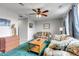 Cozy living room featuring a ceiling fan, patterned sofas, a wooden coffee table, and a vintage-style dresser at 5519 Genoa St, Denver, CO 80249