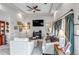 Bright and airy living room featuring a tray ceiling, a cozy fireplace, and comfortable seating at 5519 Genoa St, Denver, CO 80249