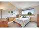 Cozy bedroom with large windows and neutral walls with a comfortable bed at 11875 W 107Th Ave, Broomfield, CO 80021