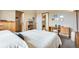 Light-filled bedroom featuring neutral walls, carpet and a wooden desk at 11875 W 107Th Ave, Broomfield, CO 80021
