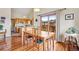 Dining area with hardwood floors, slider to patio and a view of the updated kitchen with modern appliances at 11875 W 107Th Ave, Broomfield, CO 80021