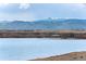 Scenic lake view with mountains, showcasing the natural beauty surrounding the property at 11875 W 107Th Ave, Broomfield, CO 80021