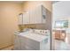 Convenient laundry room features modern appliances and ample cabinet space for storage at 11875 W 107Th Ave, Broomfield, CO 80021