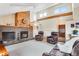 Inviting living room featuring a brick fireplace, high ceilings, and comfortable seating, creating a cozy atmosphere at 11875 W 107Th Ave, Broomfield, CO 80021