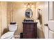 Charming powder room with a vanity, oval mirror, and decorative wallpaper at 6432 E Jamison Cir, Centennial, CO 80112
