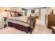 Comfortable bedroom featuring a king bed, carpeted floors, and natural light at 6432 E Jamison Cir, Centennial, CO 80112