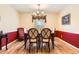 Well-lit dining room featuring a chandelier, dining table, and window with valance at 6432 E Jamison Cir, Centennial, CO 80112