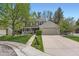 Charming two-story home with a well-manicured lawn and a welcoming front porch at 6432 E Jamison Cir, Centennial, CO 80112