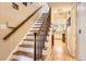 Staircase leading to the second floor, featuring a wooden banister and open hallway at 6432 E Jamison Cir, Centennial, CO 80112