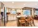 Open kitchen featuring an island with bar seating and stainless steel appliances at 6432 E Jamison Cir, Centennial, CO 80112