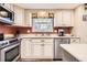 Well-lit kitchen with stainless steel appliances and white cabinetry at 6432 E Jamison Cir, Centennial, CO 80112