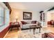 Cozy living room featuring a decorative sofa, rug, and natural light from a window at 6432 E Jamison Cir, Centennial, CO 80112