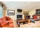 Cozy living room featuring a brick fireplace and comfortable seating at 6432 E Jamison Cir, Centennial, CO 80112