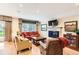 Comfortable living room with natural light, brick fireplace, and hardwood floors at 6432 E Jamison Cir, Centennial, CO 80112