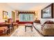 Bright living room featuring an oriental rug, sofa, and plenty of natural light at 6432 E Jamison Cir, Centennial, CO 80112