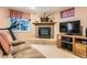 Basement rec room with brick fireplace and a comfortable beige recliner at 6432 E Jamison Cir, Centennial, CO 80112