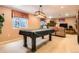 Spacious rec room with a covered pool table, treadmill, and a comfortable couch at 6432 E Jamison Cir, Centennial, CO 80112