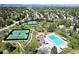 Aerial view of community amenities, including pool and tennis courts surrounded by trees at 6432 E Jamison S Cir, Centennial, CO 80112