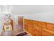 Spacious attic hallway with hardwood floors, wooden cabinets, and a charming staircase with wooden railing at 821 Collyer St, Longmont, CO 80501