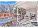 Charming covered back porch with comfortable seating, a dining table, and scenic backyard views at 821 Collyer St, Longmont, CO 80501