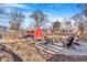 Backyard featuring a red shed, graveled area with Adirondack chairs, and a fire pit at 821 Collyer St, Longmont, CO 80501