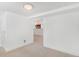 Spacious basement room featuring neutral carpet, white walls, and a view into an adjacent area at 821 Collyer St, Longmont, CO 80501