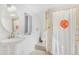 Bathroom featuring glass block shower and round mirror at 821 Collyer St, Longmont, CO 80501