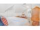 Bright bedroom with sloped ceilings, hardwood floors, a plush bed, and an ensuite bathroom at 821 Collyer St, Longmont, CO 80501