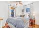 Cozy bedroom with hardwood floors, natural light, and comfortable furnishings creating a serene retreat at 821 Collyer St, Longmont, CO 80501