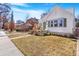 Charming home with a green lawn and a cozy front porch with a small seating area at 821 Collyer St, Longmont, CO 80501