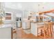 Modern kitchen with a farmhouse sink, stainless steel appliances, and wood beam accents at 821 Collyer St, Longmont, CO 80501