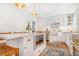 Bright kitchen featuring white cabinetry, stainless steel appliances, and a large island at 821 Collyer St, Longmont, CO 80501