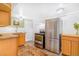 Functional kitchen with stainless steel appliances, wood cabinets, and a cozy rug at 821 Collyer St, Longmont, CO 80501