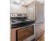 Kitchen featuring stainless steel stove and refrigerator with laminate wood flooring at 821 Collyer St, Longmont, CO 80501