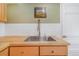 Close up of stainless steel kitchen sink with natural wood counters and a gooseneck faucet and subway tile backsplash at 821 Collyer St, Longmont, CO 80501