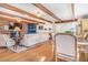 Open-concept living space with a brick fireplace, hardwood floors, stylish furnishings, and seamless flow to the kitchen at 821 Collyer St, Longmont, CO 80501