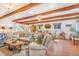 Spacious living room with exposed beam ceilings, hardwood floors, stylish furnishings, and abundant natural light at 821 Collyer St, Longmont, CO 80501