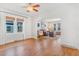 Inviting living room featuring gleaming hardwood floors, arched doorways, large windows, and decorative touches throughout at 821 Collyer St, Longmont, CO 80501