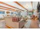Comfortable living room and dining area with exposed beam ceilings, hardwood floors, and a cozy atmosphere at 821 Collyer St, Longmont, CO 80501