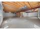 Unfinished basement with concrete floors and exposed ceiling at 8985 Edgewood Ln, Highlands Ranch, CO 80130