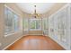 Bright dining room with hardwood floors and large windows providing natural light at 8985 Edgewood Ln, Highlands Ranch, CO 80130