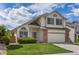 Inviting two-story home featuring a well-kept lawn, charming windows and a two-car garage at 8985 Edgewood Ln, Highlands Ranch, CO 80130