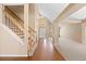 Welcoming foyer with hardwood floors, staircase, and views into the adjacent living spaces at 8985 Edgewood Ln, Highlands Ranch, CO 80130